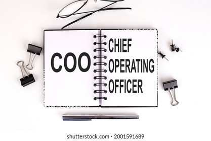 Notebook With COO- Chief Operating Officer On Table