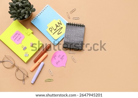 Notebook with to do plans, sticky notes and calendar on beige background. New year goals concept