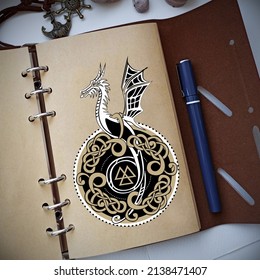 Notebook with dragon medallion in scandinavian style. Travel book in leather cover. Fantasy notebook mockup. High quality photo.