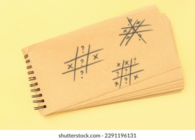 Notebook with drawn question marks on yellow background