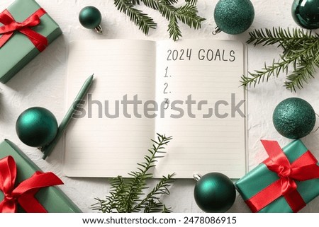 Notebook with empty to do list and Christmas decor on white grunge background