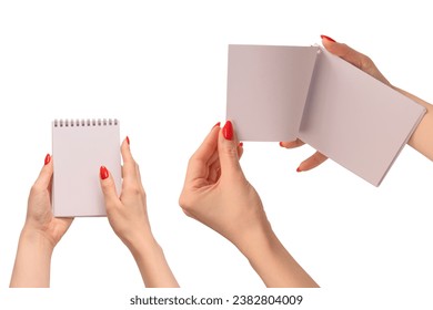 A notebook with empty white paper in woman hands with red nails. Copy space. 