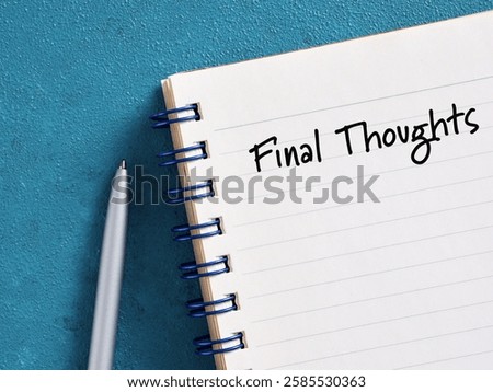 Notebook with final thoughts handwritten on the first page, placed on a blue surface next to a pen, evoking concepts of summary, conclusion, and reflection