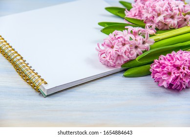 Notebook and flowers on the table. spring mood