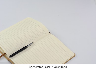Notebook and fountain pen isolated on white background.