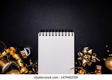 Notebook And Gift Box With Golden Bow On Black Background With Stars And Sparkles. Festive  And Wish List . New Year Resolution Concept Copyspace Top Horizontal View. Sticky Tape, Christmas 