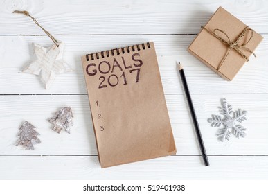 notebook and goals for new year wooden background top view - Powered by Shutterstock