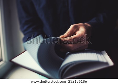 notebook in the hands of Man