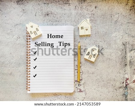 Notebook with Home Selling Tips Text .Selling , business and mortgage concept. Top view 
