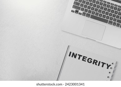 Notebook with integrity text on a white background. Reputation integrity concept