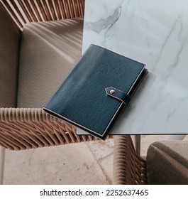 Notebook, Journal, blue diary add your own logo or text, mockup, coffee and table in a cafe 