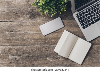 Notebook And Laptop On Old Wooden Desk