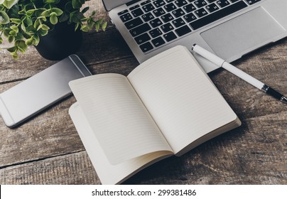 Notebook And Laptop On Old Wooden Desk