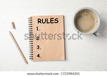Notebook with list of rules and cup of coffee on wooden background, flat lay