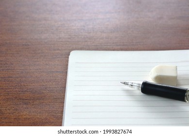 A Notebook, A Mechanical Pencil, And An Eraser.