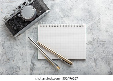 Notebook mock up for artwork with film camera and lens. Top view. - Shutterstock ID 551496187