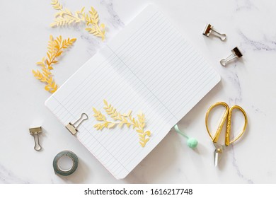 Notebook mock-up with scissors top view 