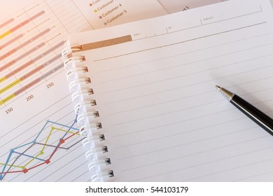 notebook or notepad blank with a graph paper close up, It has been on office desk for work, business concept.