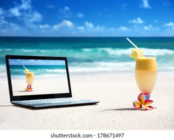 notebook on the beach and glass of fresh juice - Powered by Shutterstock