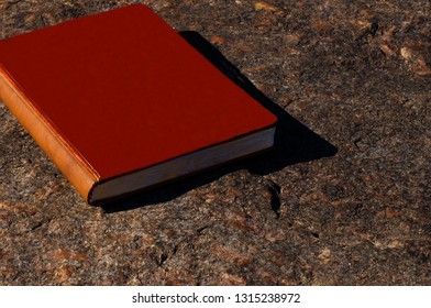 notebook on a stone wall