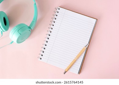 Notebook on the table. Blank notebook with space for a message. Pens, headphones