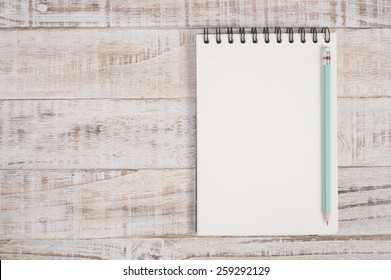 Notebook on wood table for background - Powered by Shutterstock