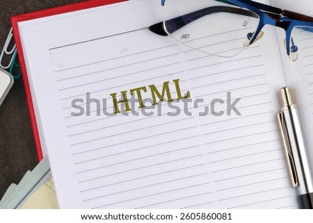 A notebook page displays the term HTML, while reading glasses and a pen rest nearby on a study desk cluttered with books and notes.