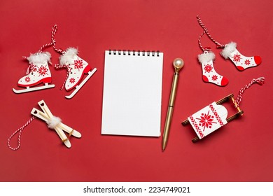 Notebook, pen, Christmas decor on red background Christmas shopping list, New year goals, to do list concept Greeting holiday card Top view Mockup  - Powered by Shutterstock