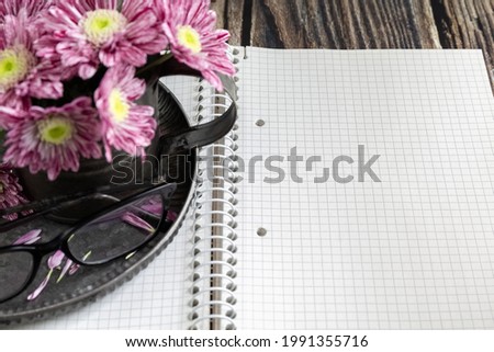 Notebook, pen, Chrysanthemums in a vase and decorative scissors. Businesswoman set. Case planning concept. Diary. BusinessConcept. High quality photo