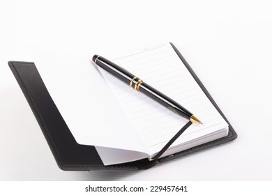 Notebook and pen isolated on white background