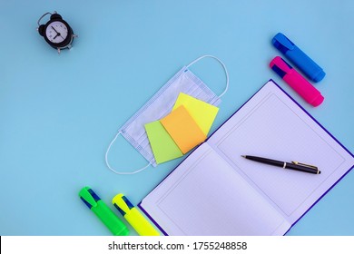 Notebook, Pen, Note Paper, Alarm Clock, Face Mask On A Blue Background, Back To School