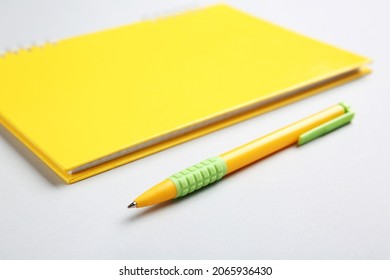 Notebook and pen on light background