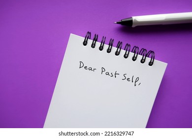 Notebook And Pen On Purple Background With Handwritten Text DEAR PAST SELF, Concept Of Self Reflection - Writing Letter To The Person You Were, Advice To Give To Tell About What Happened Then And Now