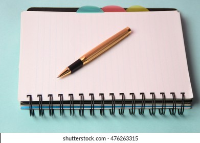 Notebook and pen. Open diary and pen to record
