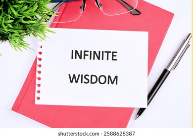 A notebook and a pen are presented with a message about infinite wisdom, focusing on education, business, and finance themes for learners and professionals.
