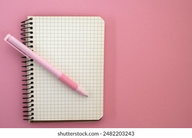 A notebook and a pen. Space for notes. A form for writing. An open blank notebook. Notebook on a spiral. Making a plan. Planning. Diary for notes. A place to write in a notebook. Open diary - Powered by Shutterstock