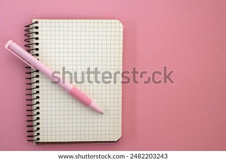 A notebook and a pen. Space for notes. A form for writing. An open blank notebook. Notebook on a spiral. Making a plan. Planning. Diary for notes. A place to write in a notebook. Open diary