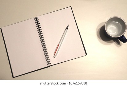 Notebook, Pen And Water On Desk; All White Desk Objects For Work Projects