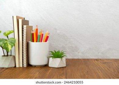 Notebook and pencil cup on table. Work desk space - Powered by Shutterstock