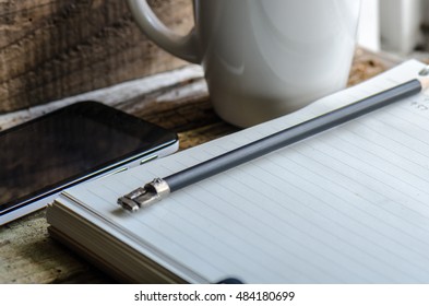 Notebook and pencil on the table.