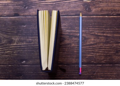 Notebook and pencil placed on the table