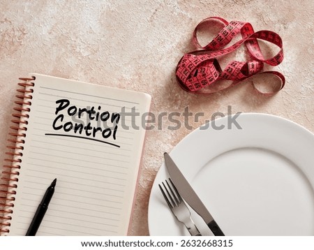 Notebook with portion control written, measuring tape and cutlery suggesting a healthy lifestyle and weight loss diet