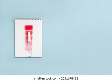 Notebook With Red Rectangles And Feminine Hygiene Tampon. Concept Intensity Of Menstrual Flow. Copy Space