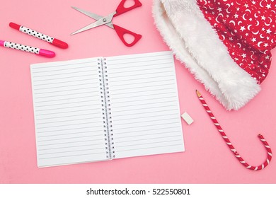 Notebook. Santa Hat In A Pink Table, Candy Canes, Scissor.Flat Lay.Overhead Shot
Christmas
