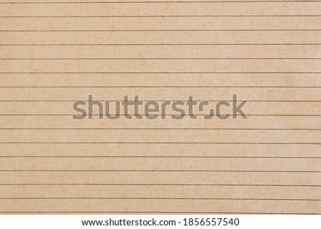 Notebook sheet in a ruler. School notebook. Lines. Brown paper. Close-up notepad sheet. Secondary use. Copy space