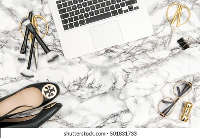 Notebook, shoes, office supplies, feminine business woman accessories on bright marble table background. Fashion shopping flat lay for blogger social media
