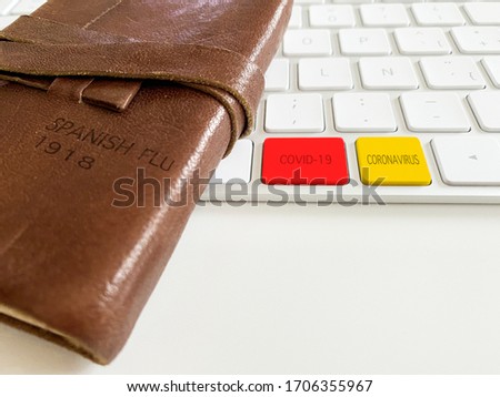 Notebook of the Spanish flu of 1918, with digital keyboard of the coronavirus 2019 with red and yellow keys
