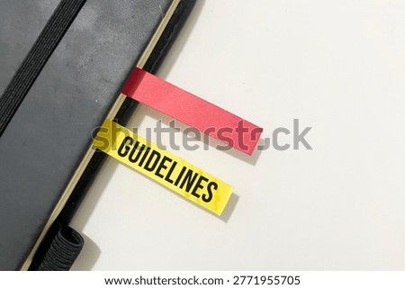 Notebook with sticky tab labeled Guidelines. Concept of rules, direction, structure, and business procedures.