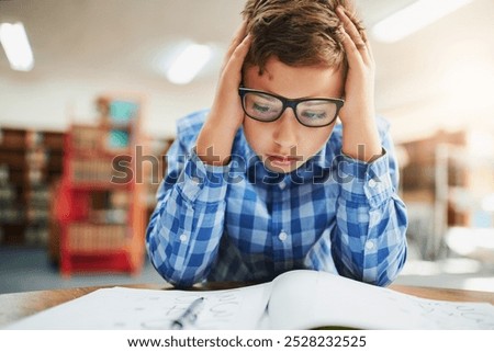 Notebook, stress and boy in classroom for study, test and child development with anxiety in education. Desk, assessment and frustrated student with learning disability, notes or exam at middle school