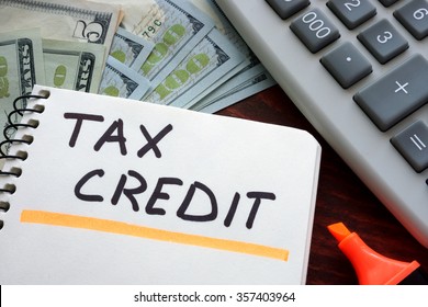 Notebook With  Tax Credit Sign On A Table. Business Concept.